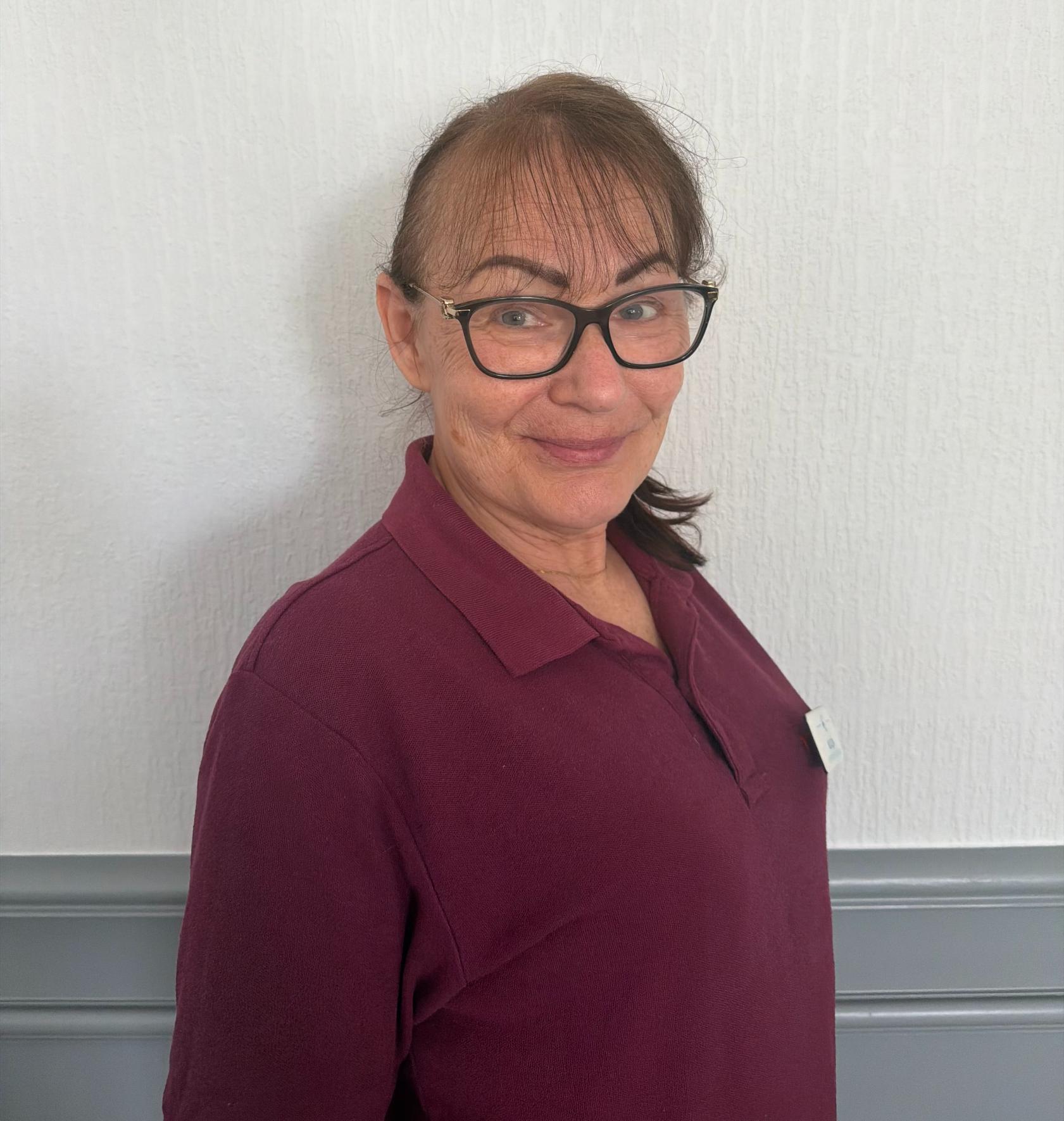 woman in maroon polo shirt