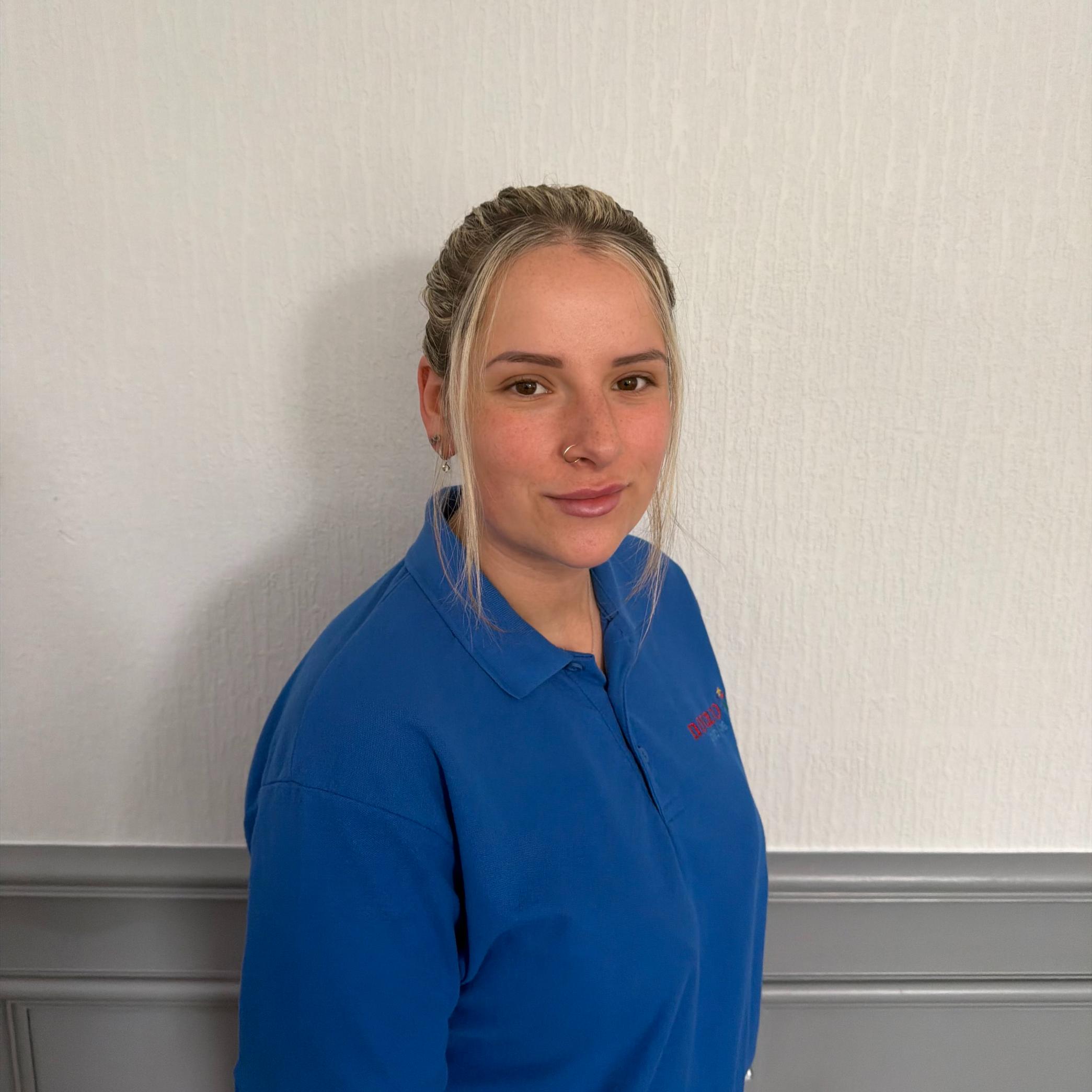 activities assistant in blue polo shirt