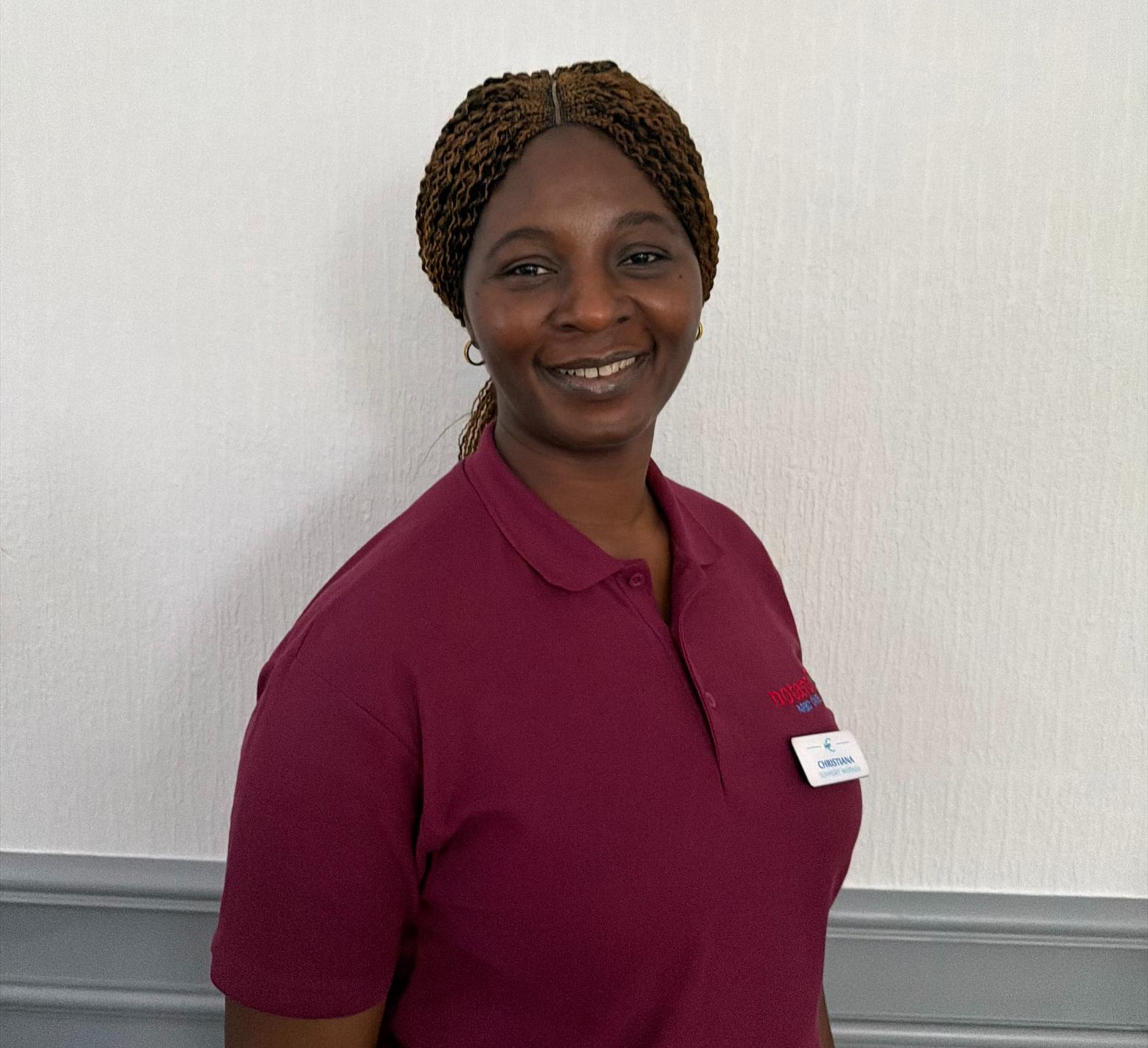 support worker in maroon polo shirt