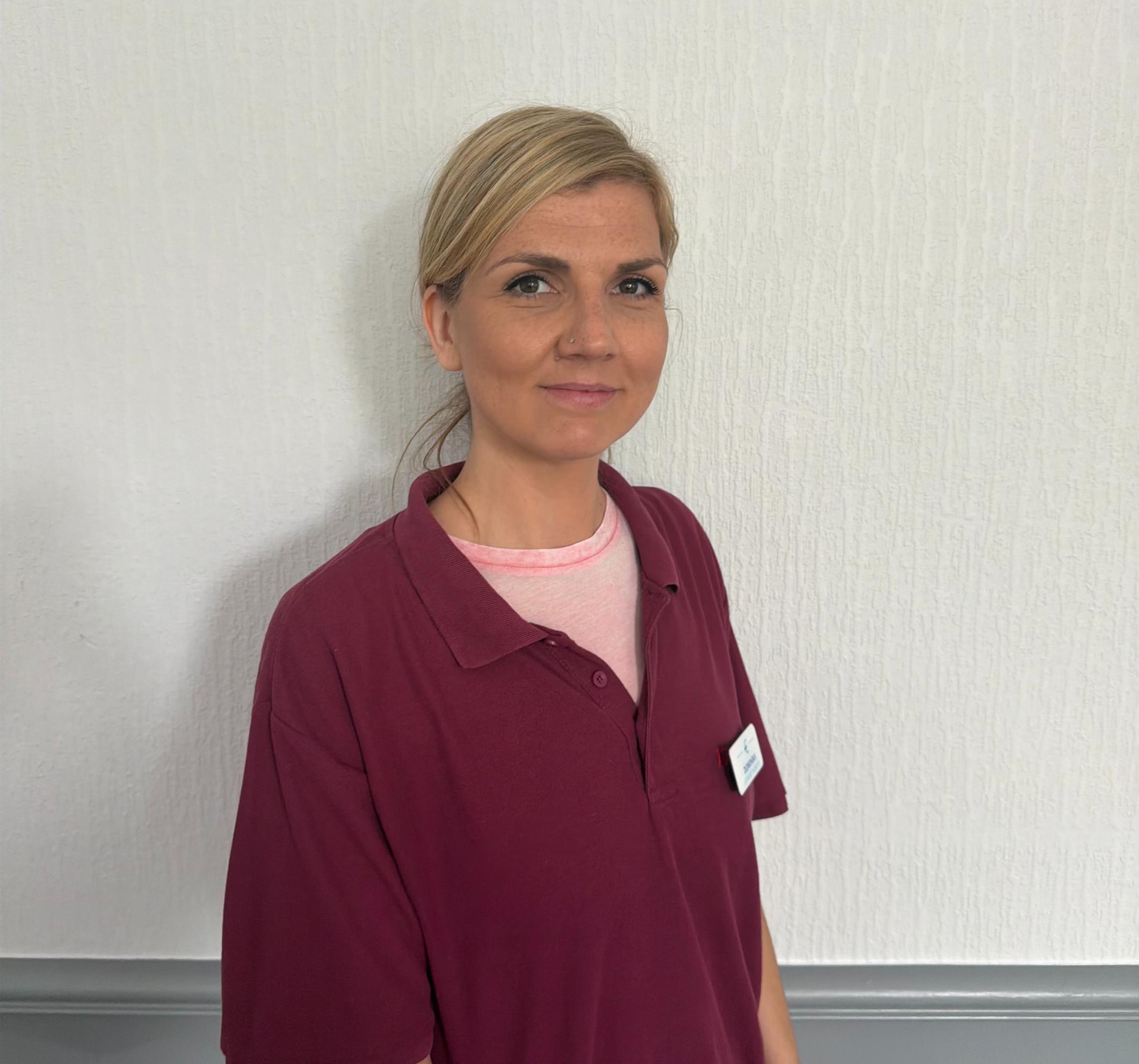 support worker in maroon polo shirt