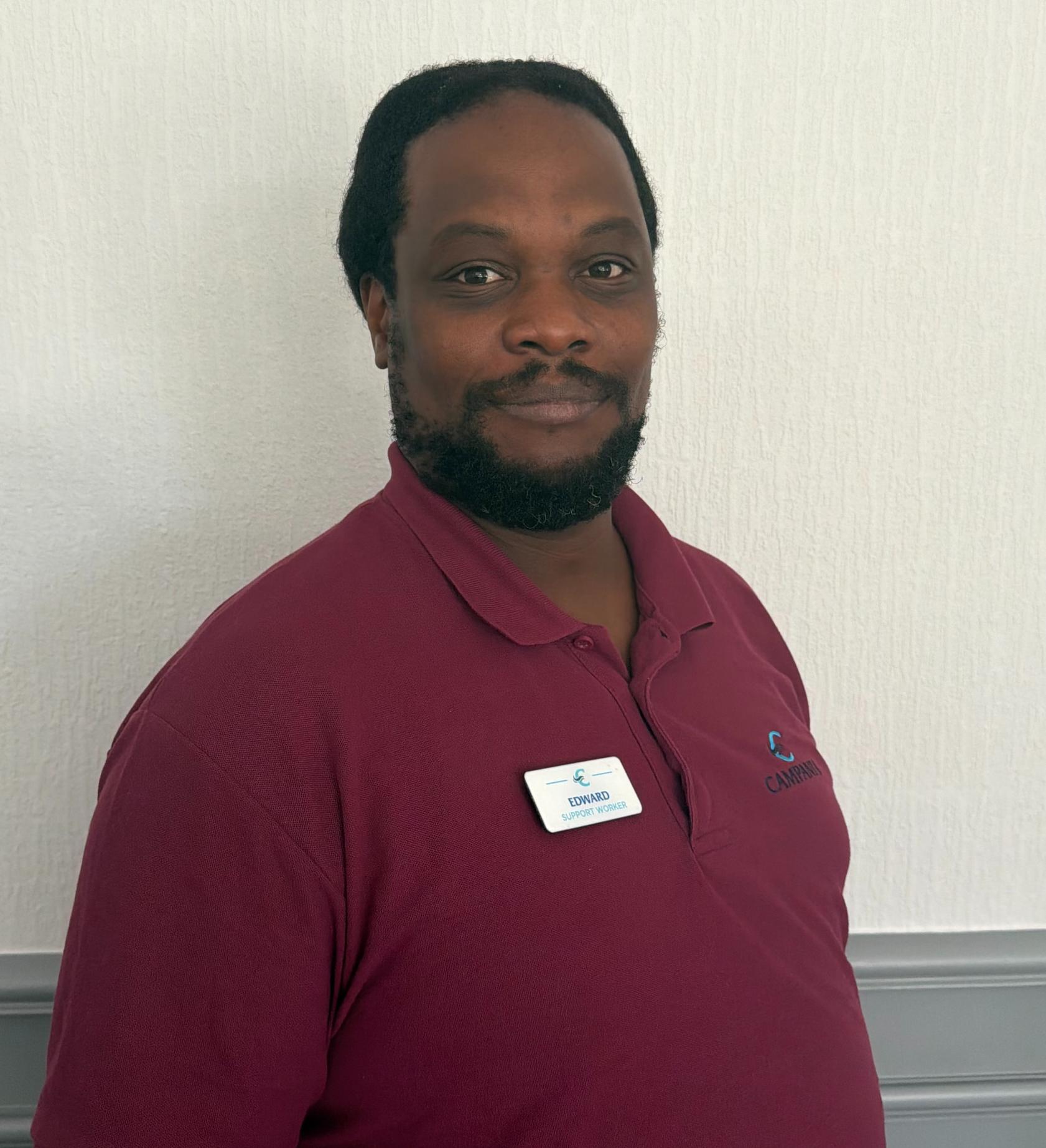 support worker in maroon polo shirt
