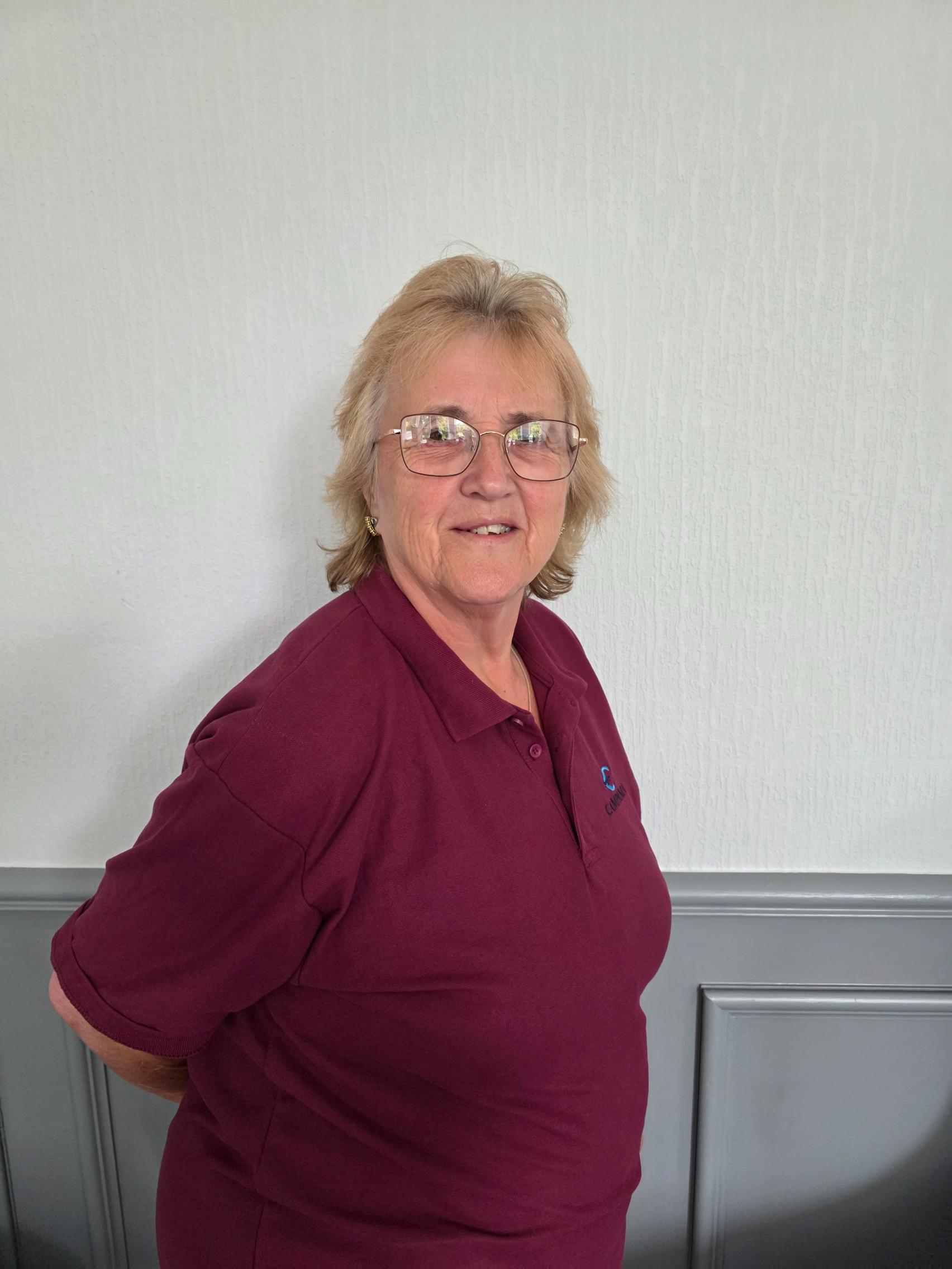 night support worker in a maroon polo shirt