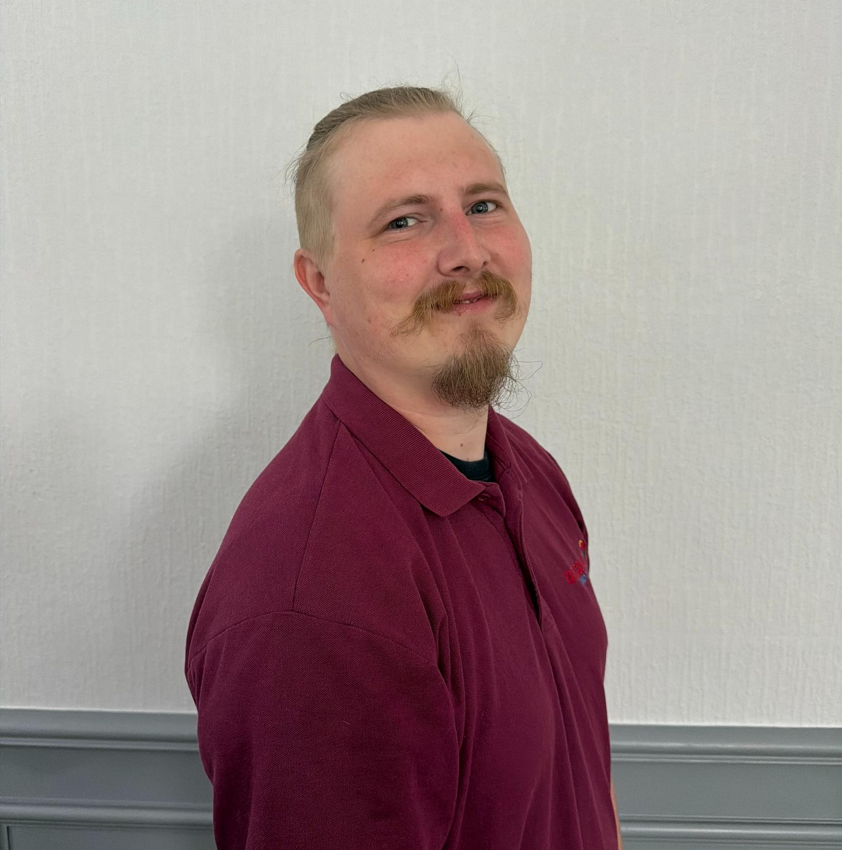 support worker in maroon polo shirt