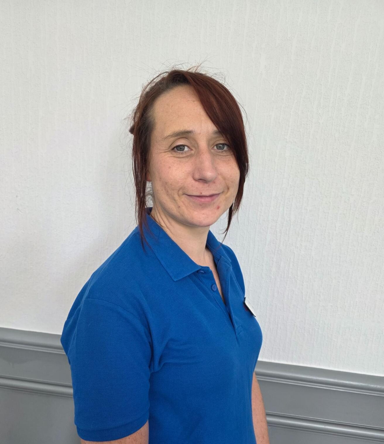 activities assistant in blue polo shirt