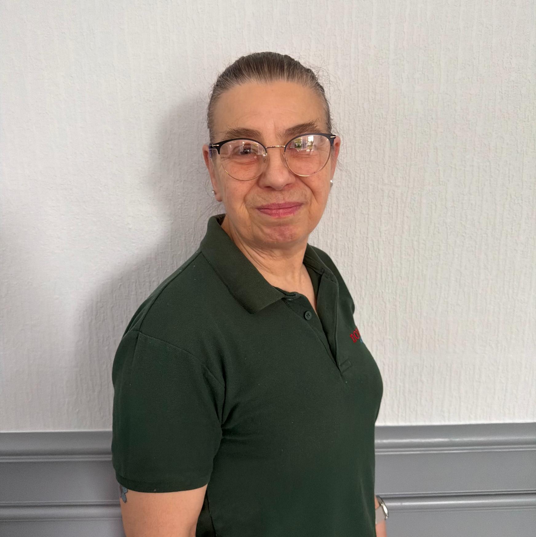 housekeeper in green uniform