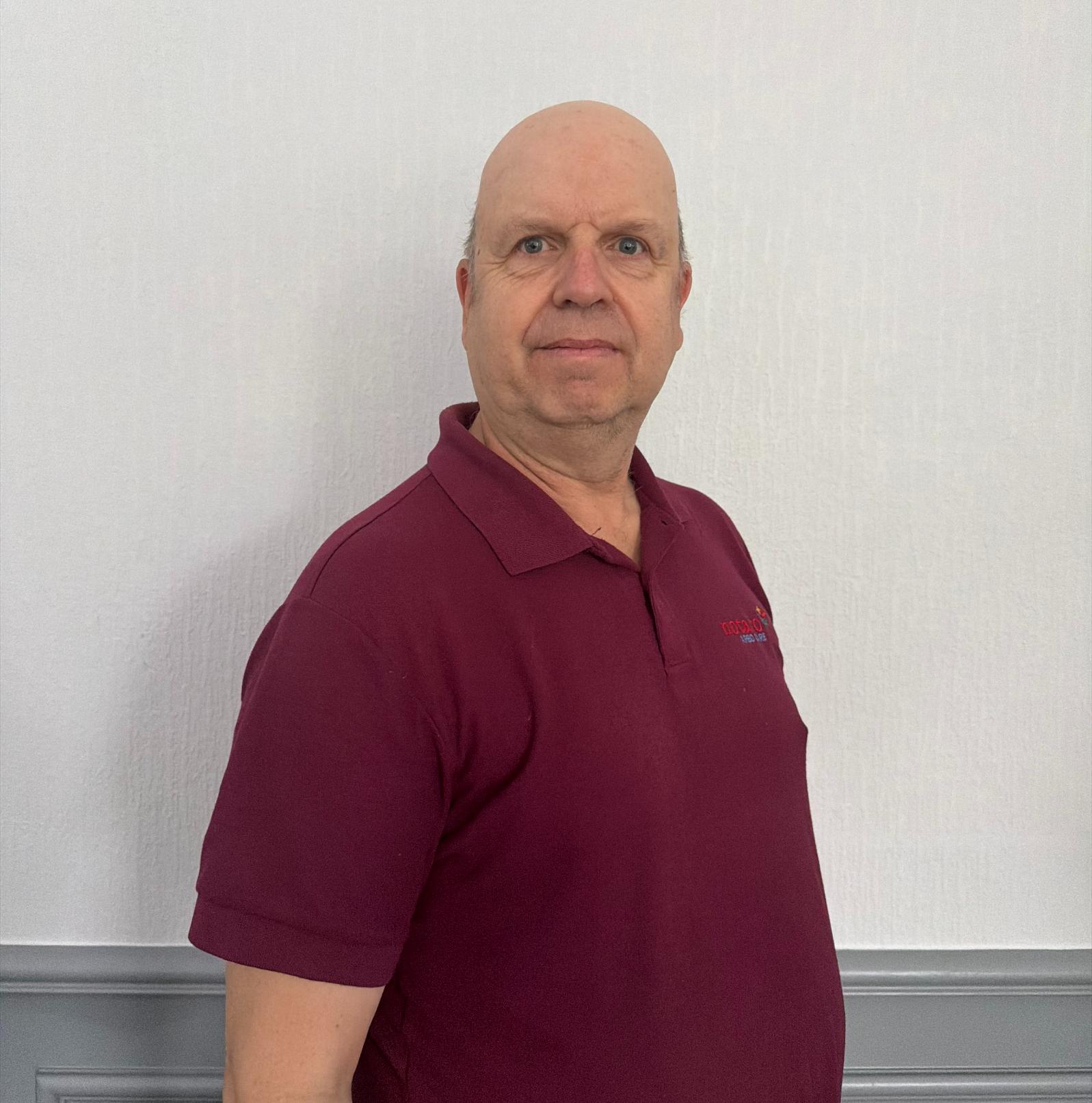 night support worker in maroon uniform