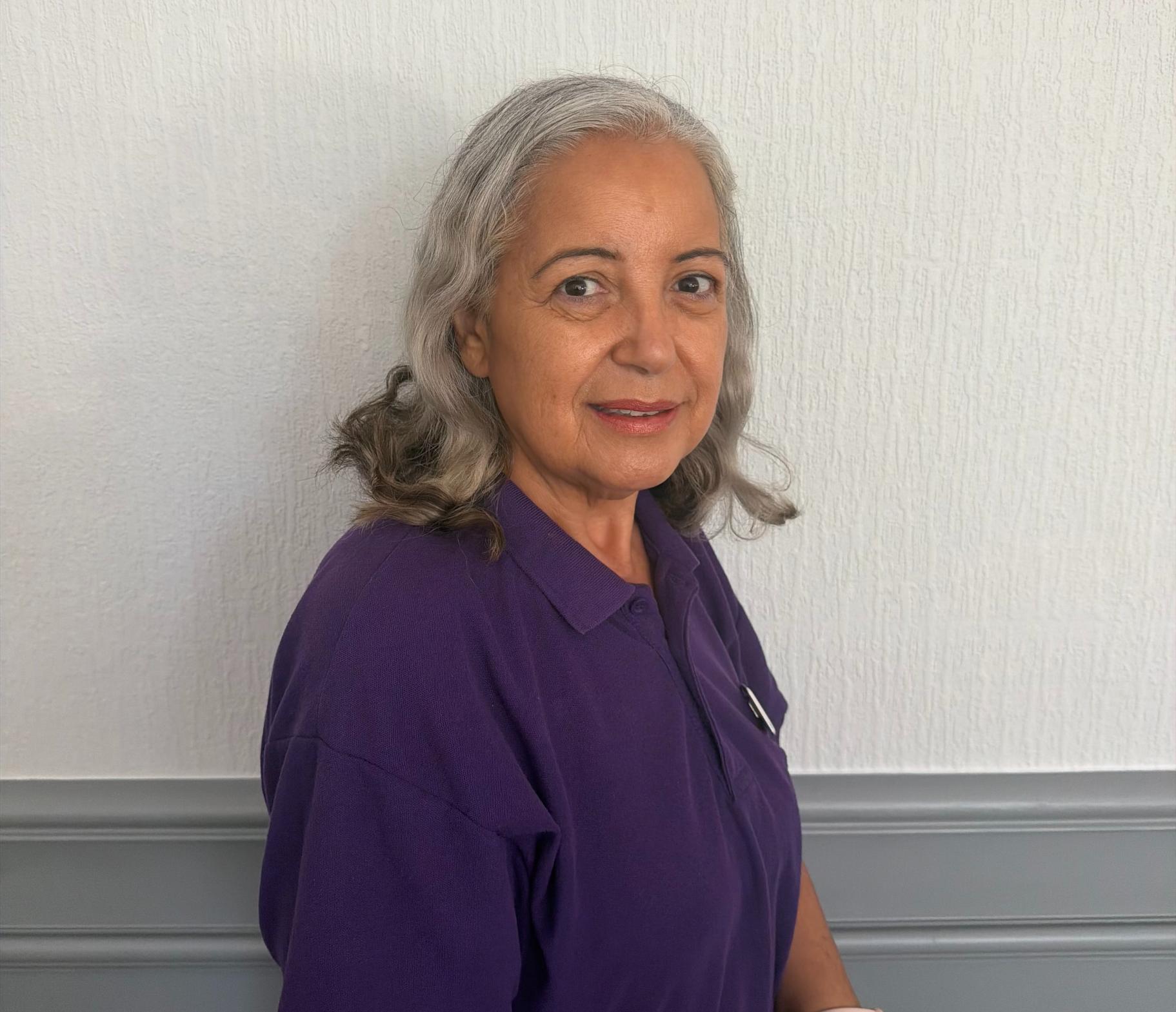 senior support worker in purple polo shirt
