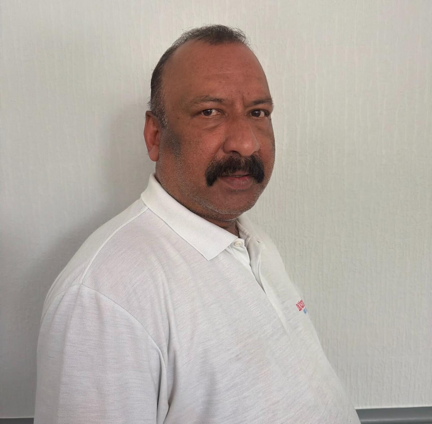 kitchen assistant in a white polo shirt