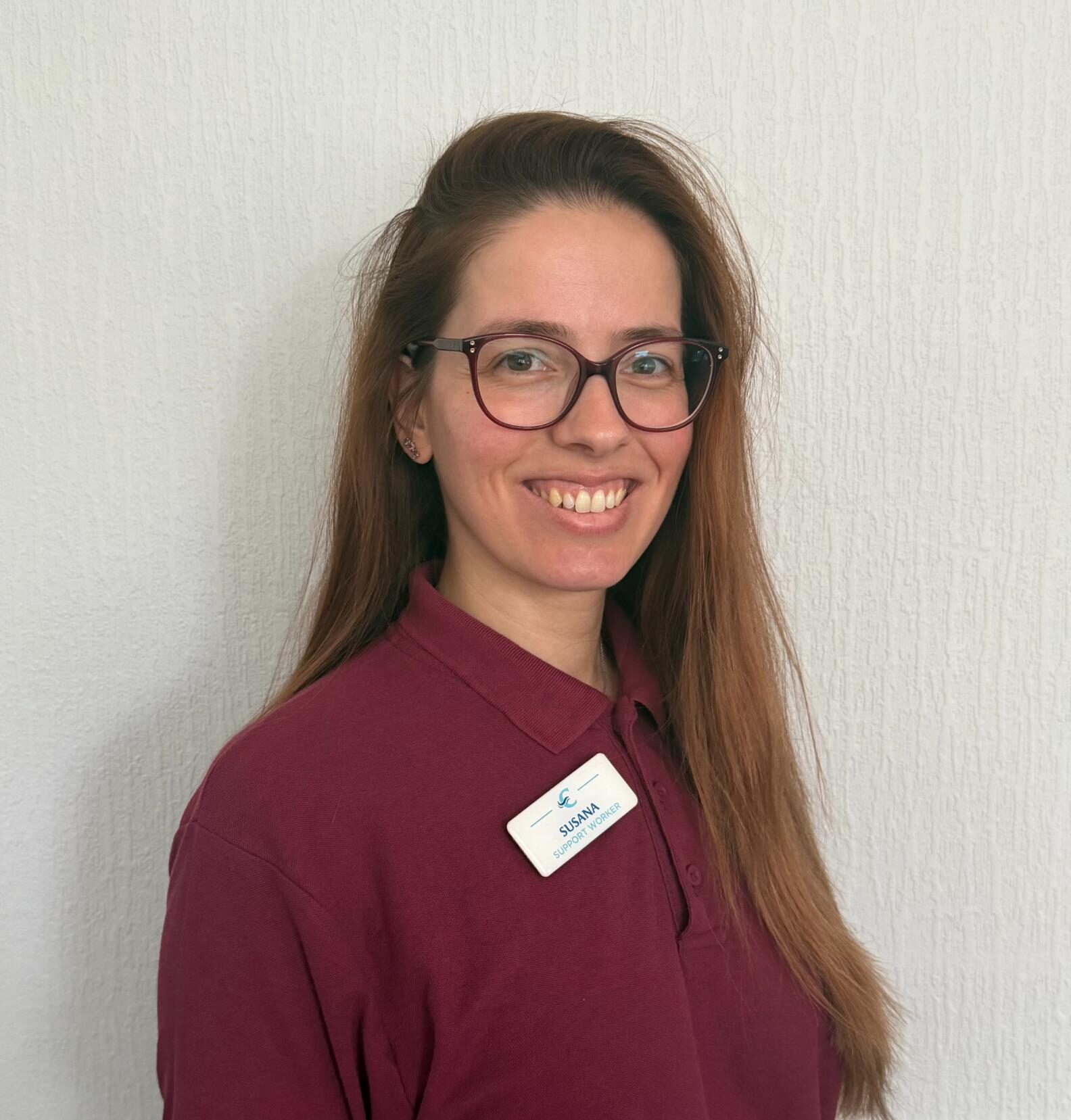 support worker in maroon polo shirt